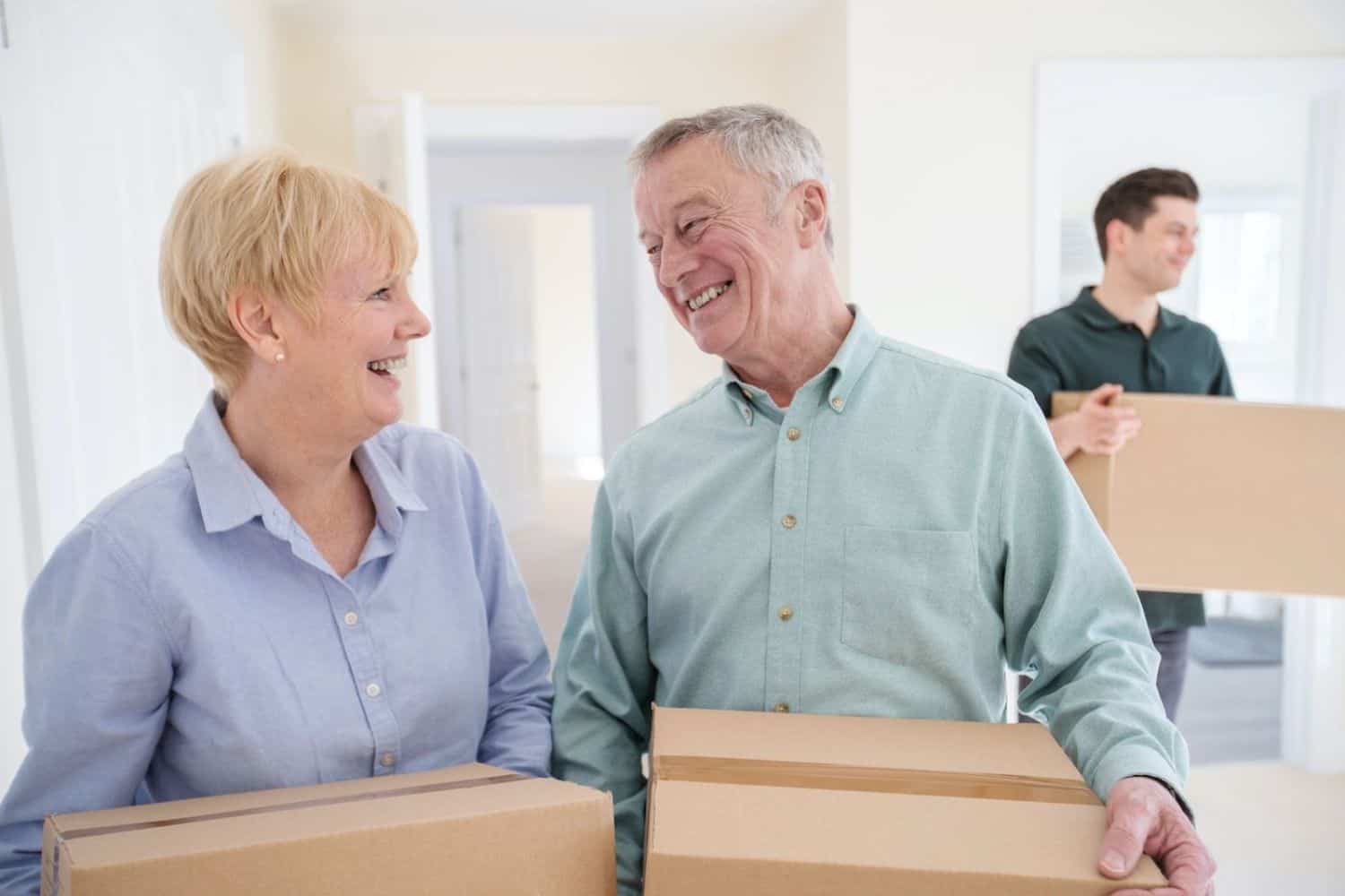 Happy couple with boxes moving into a new home in Victoria BC.