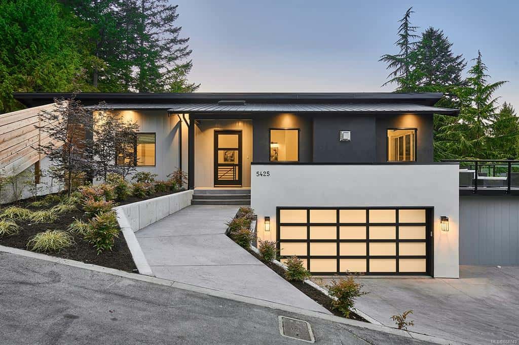 Modern single-family home by White Wolf Homes with elevated entrance and two-car garage in Victoria BC.