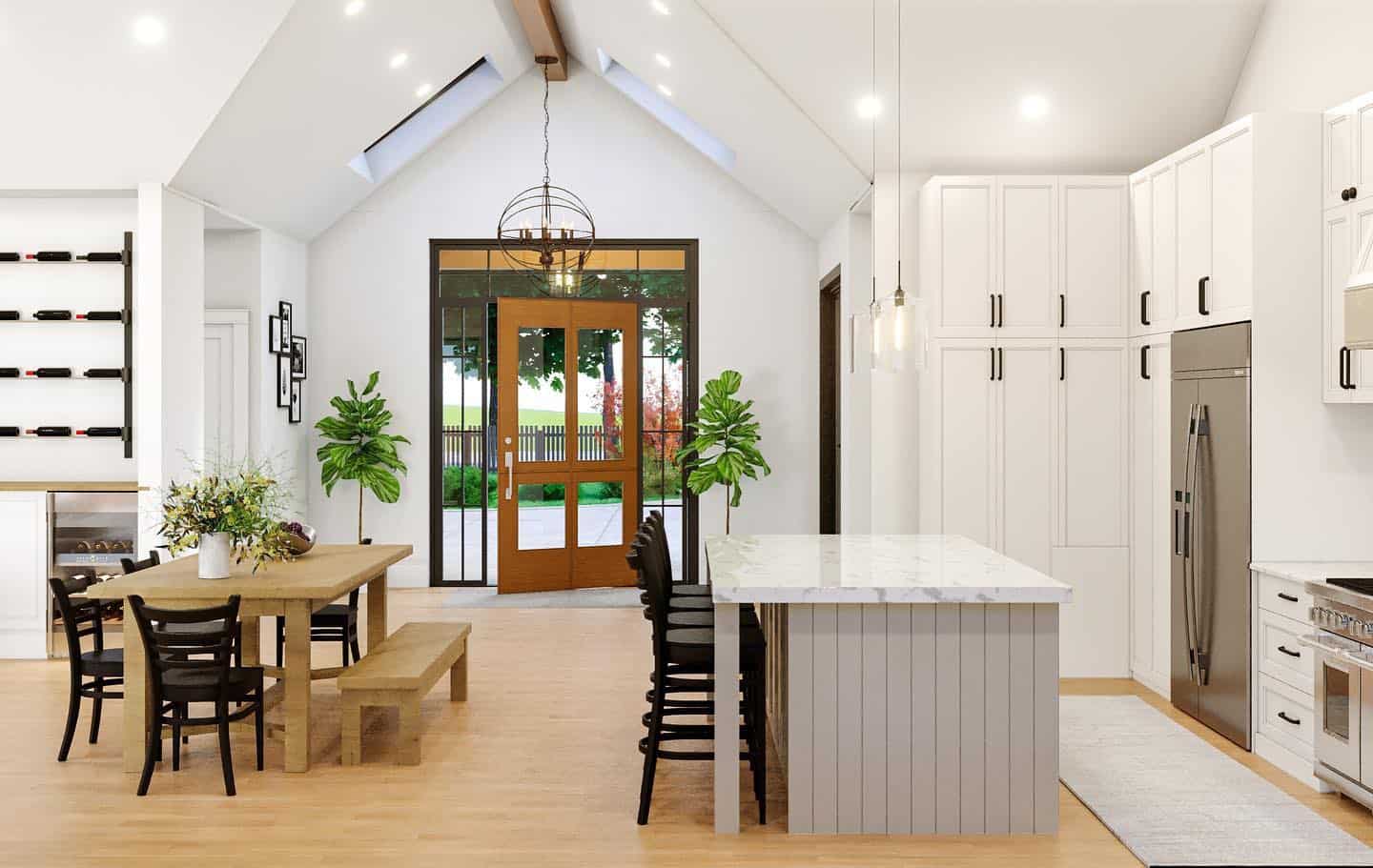 Bright open kitchen with island, dining area, and glass doors to outdoors.