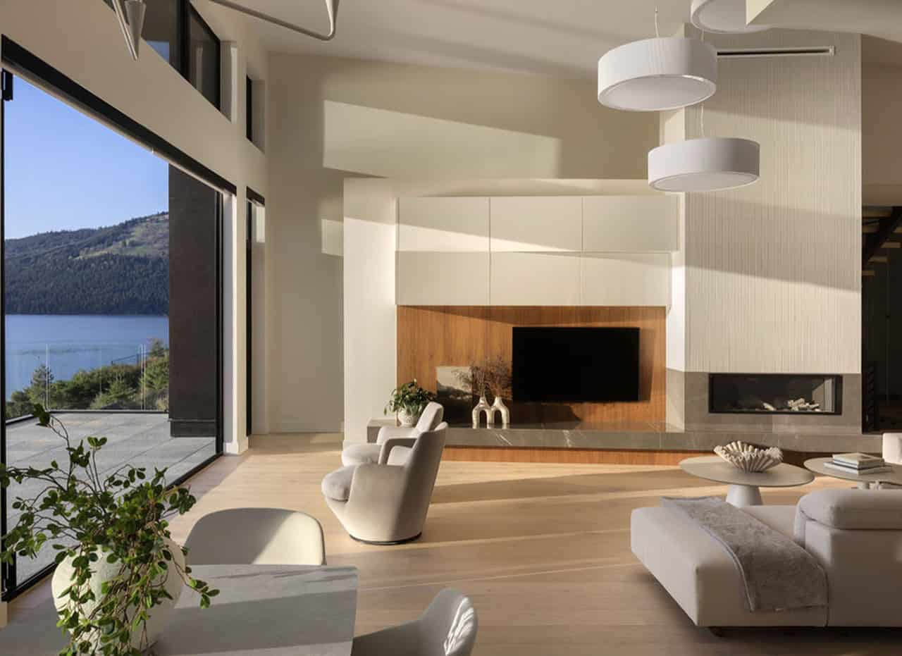 Modern living room with large windows and scenic views in a Victoria BC custom home by White Wolf Homes.