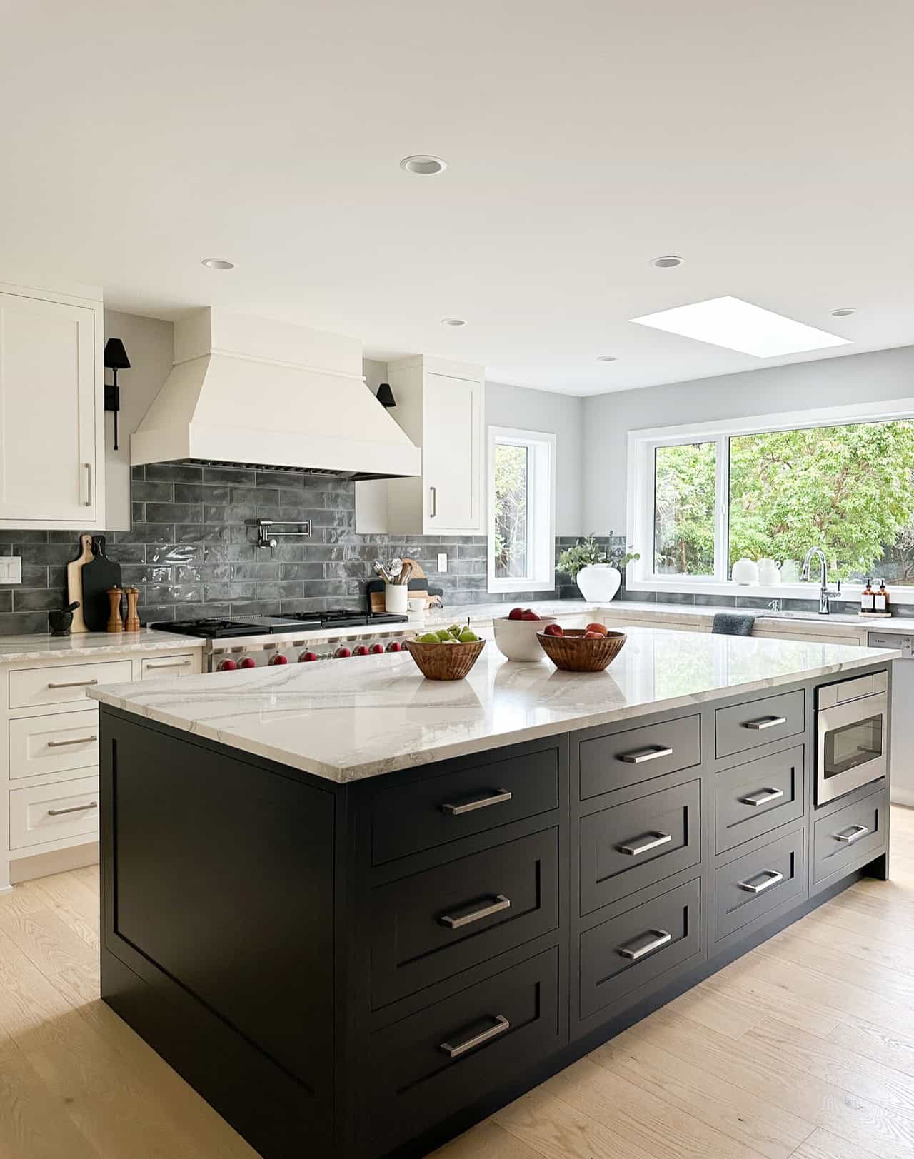 Modern white and black kitchen with large island, Victoria BC custom home by White Wolf Homes.