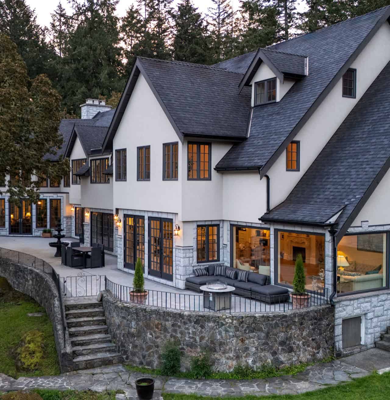 Modern stone and stucco home with large windows and expansive terrace in Victoria BC.