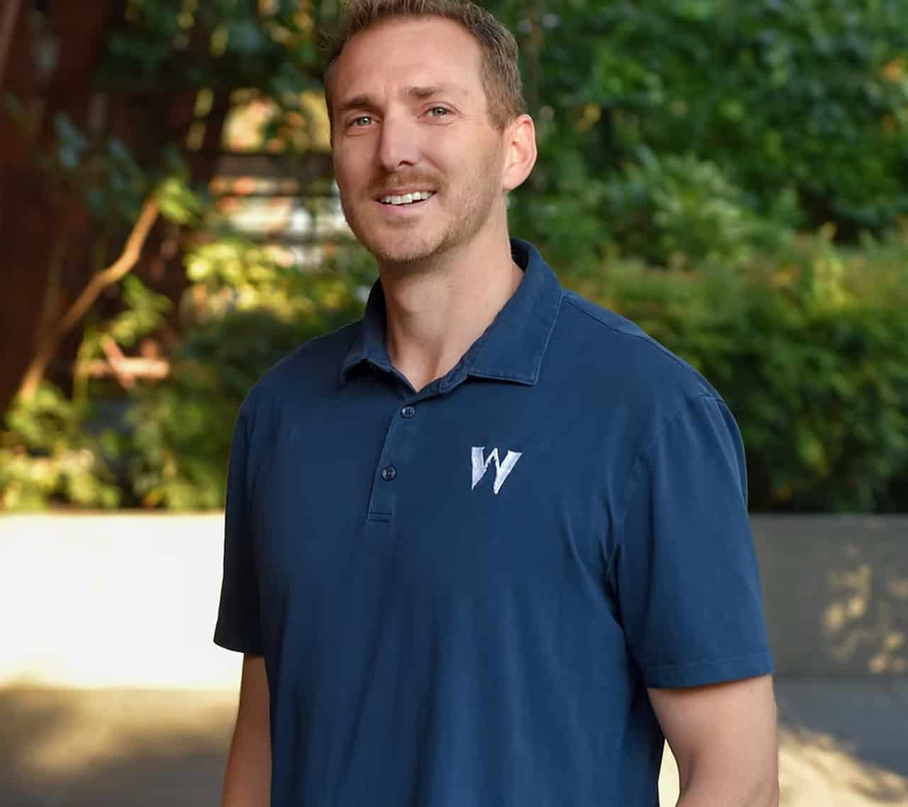 Team member in blue polo with White Wolf Homes logo (Victoria BC).