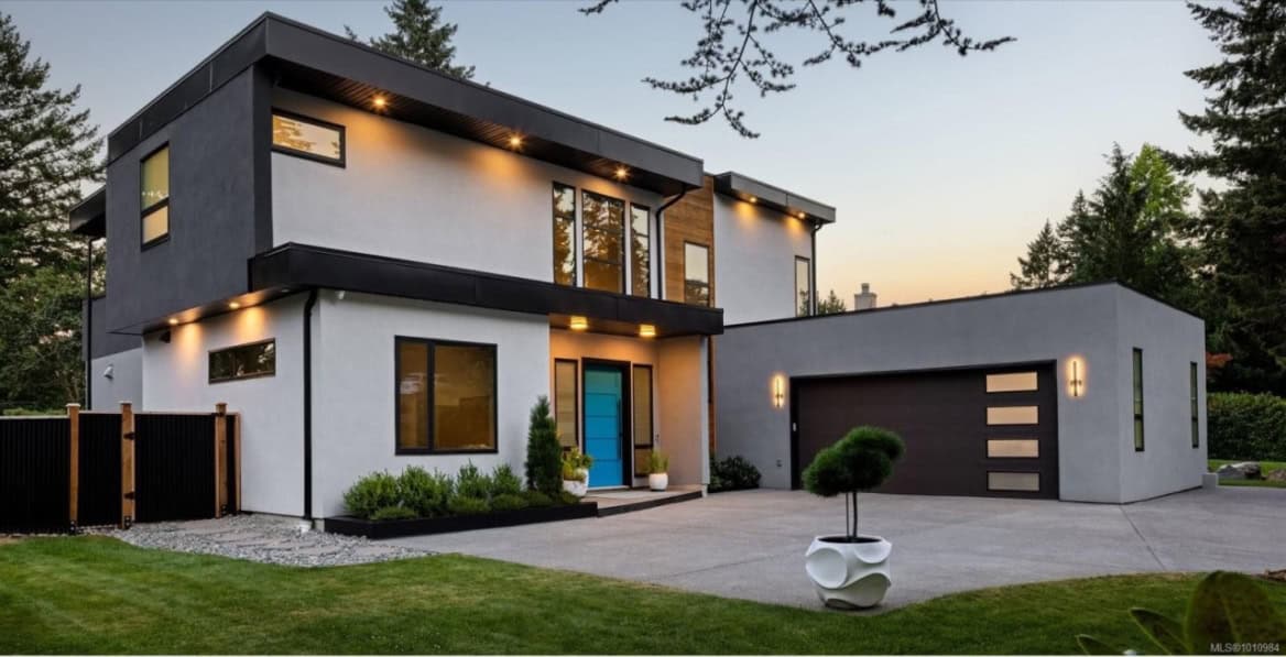 Modern two-story custom home by White Wolf Homes in Victoria BC with sleek design and attached garage.