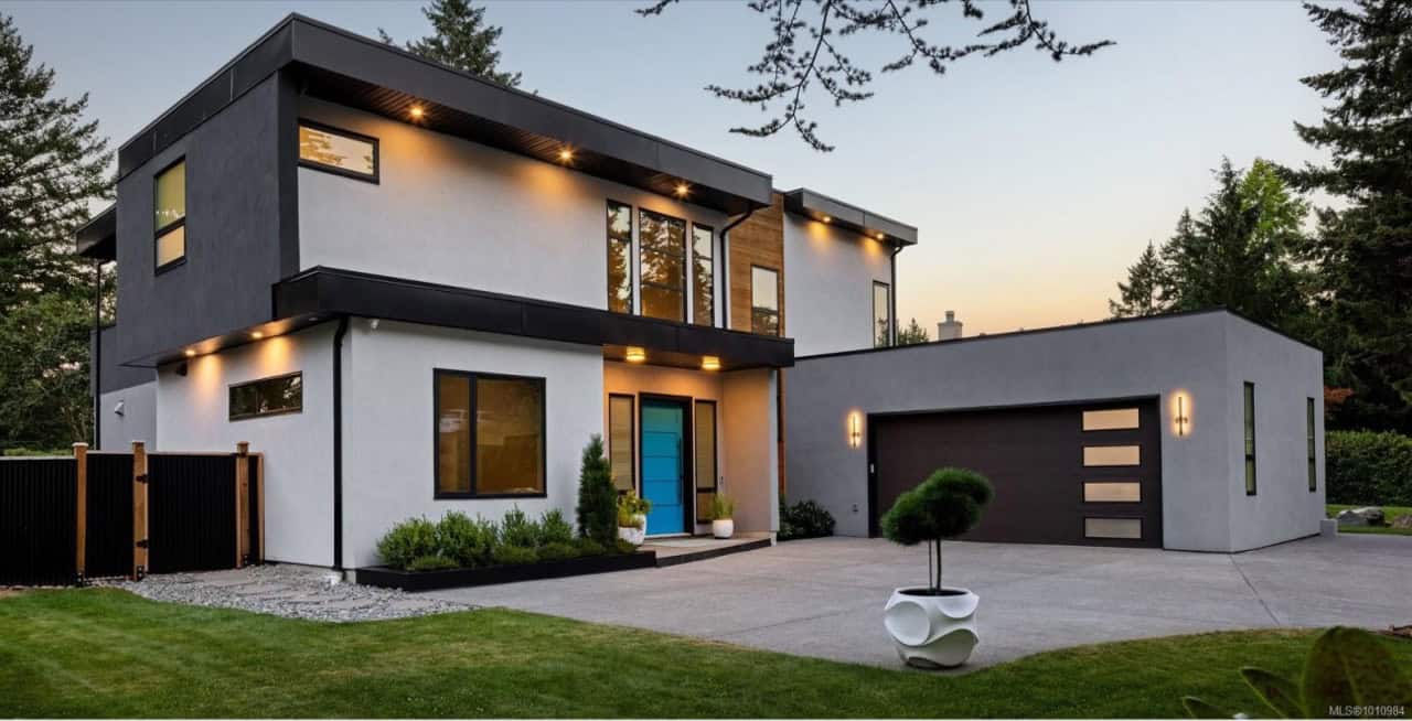 Modern two-story custom home by White Wolf Homes in Victoria BC with sleek design and attached garage.