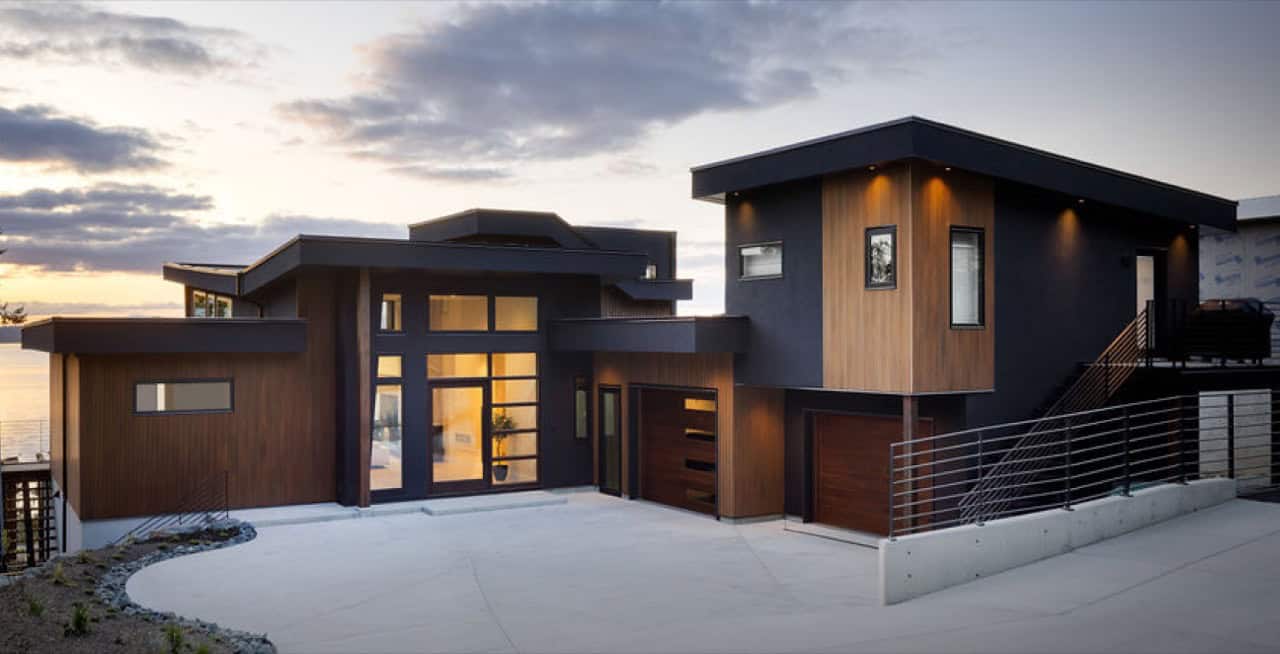 Modern custom home exterior by White Wolf Homes in Victoria BC with wood paneling and large windows.