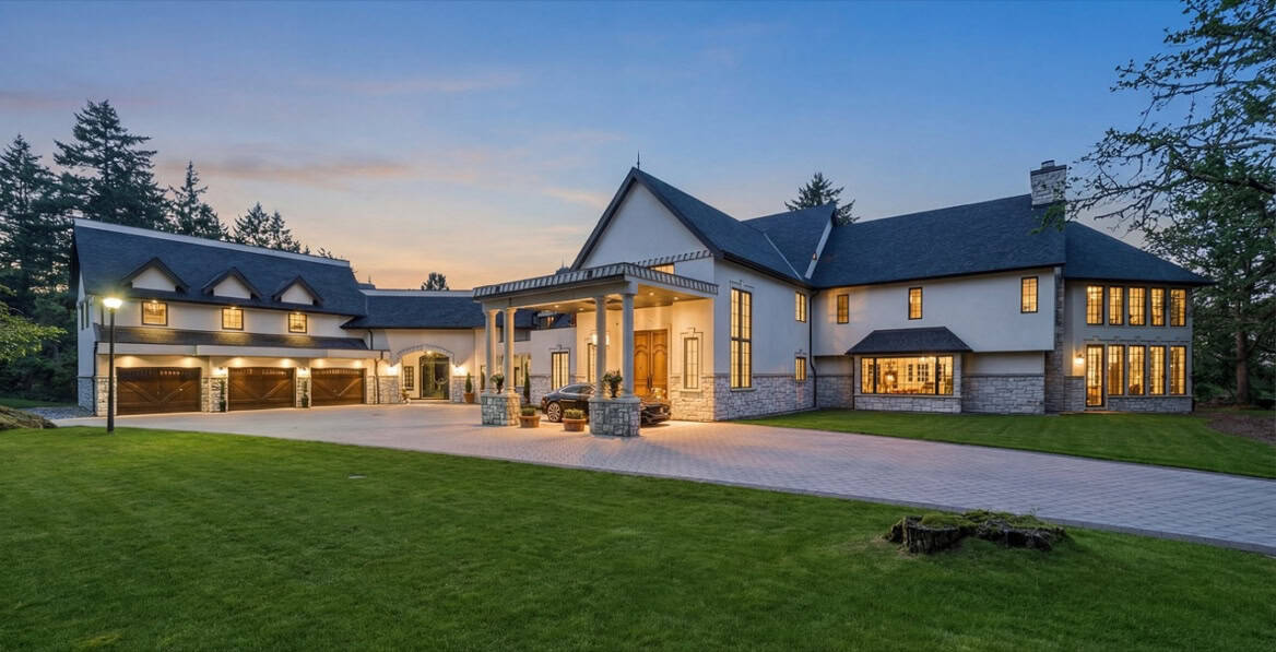 White Wolf Homes custom home exterior in Victoria BC with sunset light on the entrance and two-car garage.