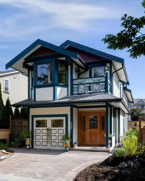 Victoria BC custom home with blue trim, double garage and front porch, modern craftsman style by White Wolf Homes.