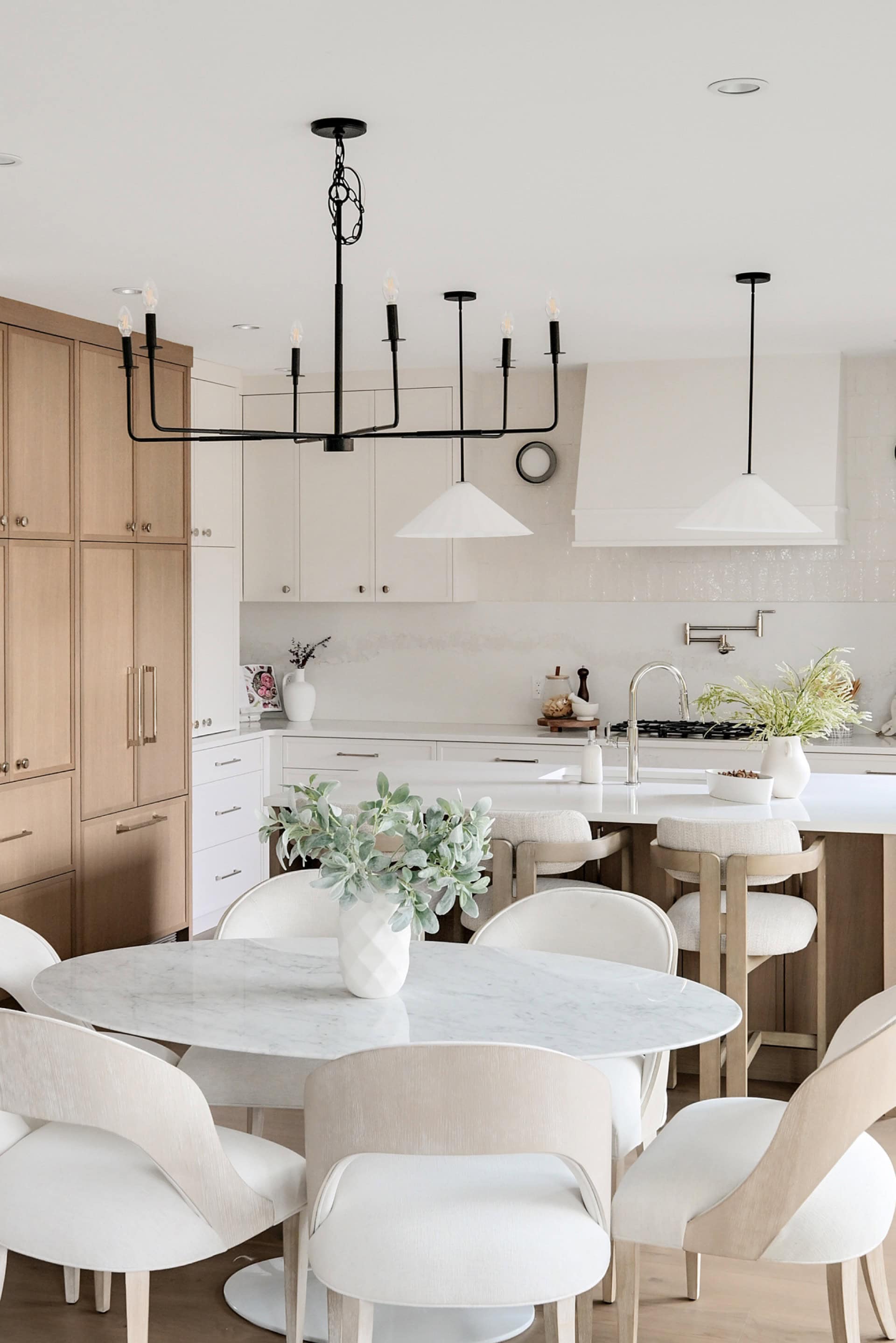 Modern kitchen with white and wood finishes in Victoria BC home by White Wolf Homes.