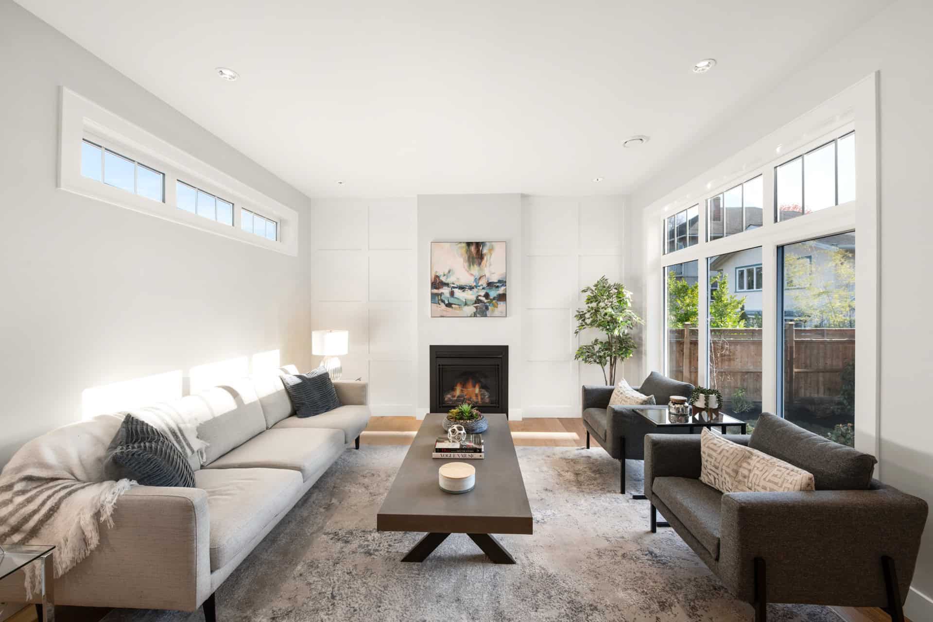 Bright modern living room with fireplace and large windows.