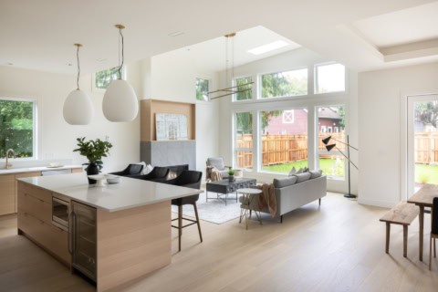 Bright open-concept living space with large windows and modern kitchen island.