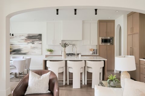 Modern open-concept kitchen with island and dining area in Victoria BC home.