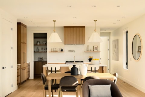 Bright modern kitchen with wooden cabinets and dining table in Oakdowne, Victoria area.