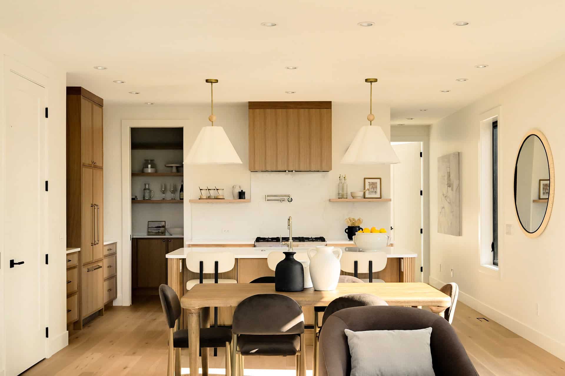 Bright modern kitchen with wooden cabinets and dining table in Oakdowne, Victoria area.