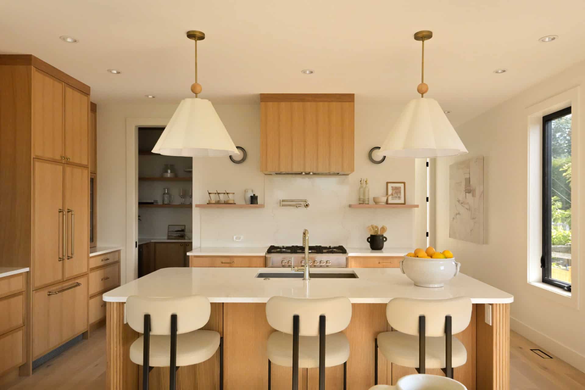 Bright, modern kitchen with wooden cabinetry and island seating in Oakdowne, Victoria BC.