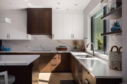 Modern kitchen with white and wood cabinetry at Haven Victoria BC.