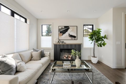 Living room interior with white sofa, fireplace, and modern decor in Victoria BC home.