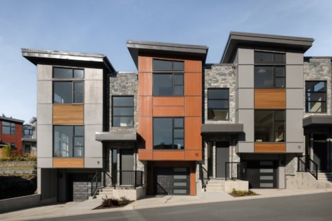 Modern townhouses in Victoria BC with mixed materials and arched entryways.