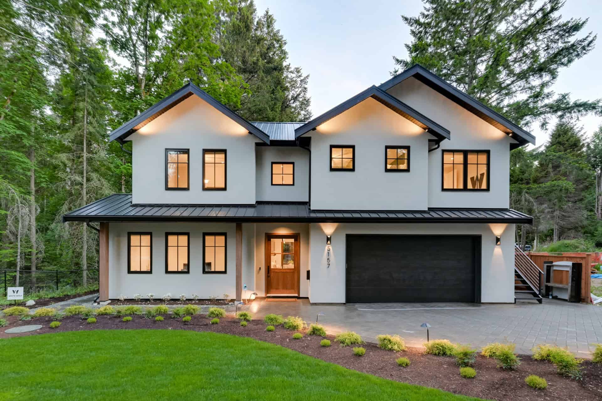 White Wolf Homes modern two-story home in Victoria BC with white and gray siding and a dark roof.