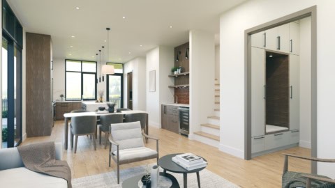 Interior view of a modern open-concept kitchen and living area with light wood floors and large clerestory windows.