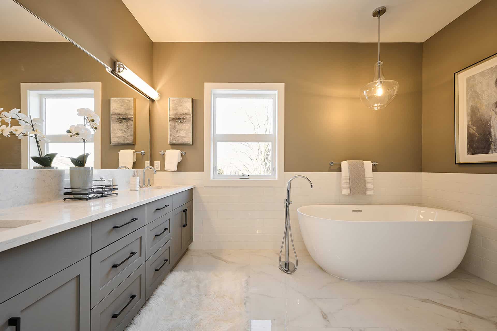 Spacious modern bathroom with freestanding tub and dual vanities in Meadowview home.
