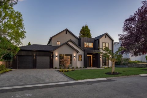 Modern two-story custom home in Victoria BC by White Wolf Homes with a three-car garage and manicured lawn.