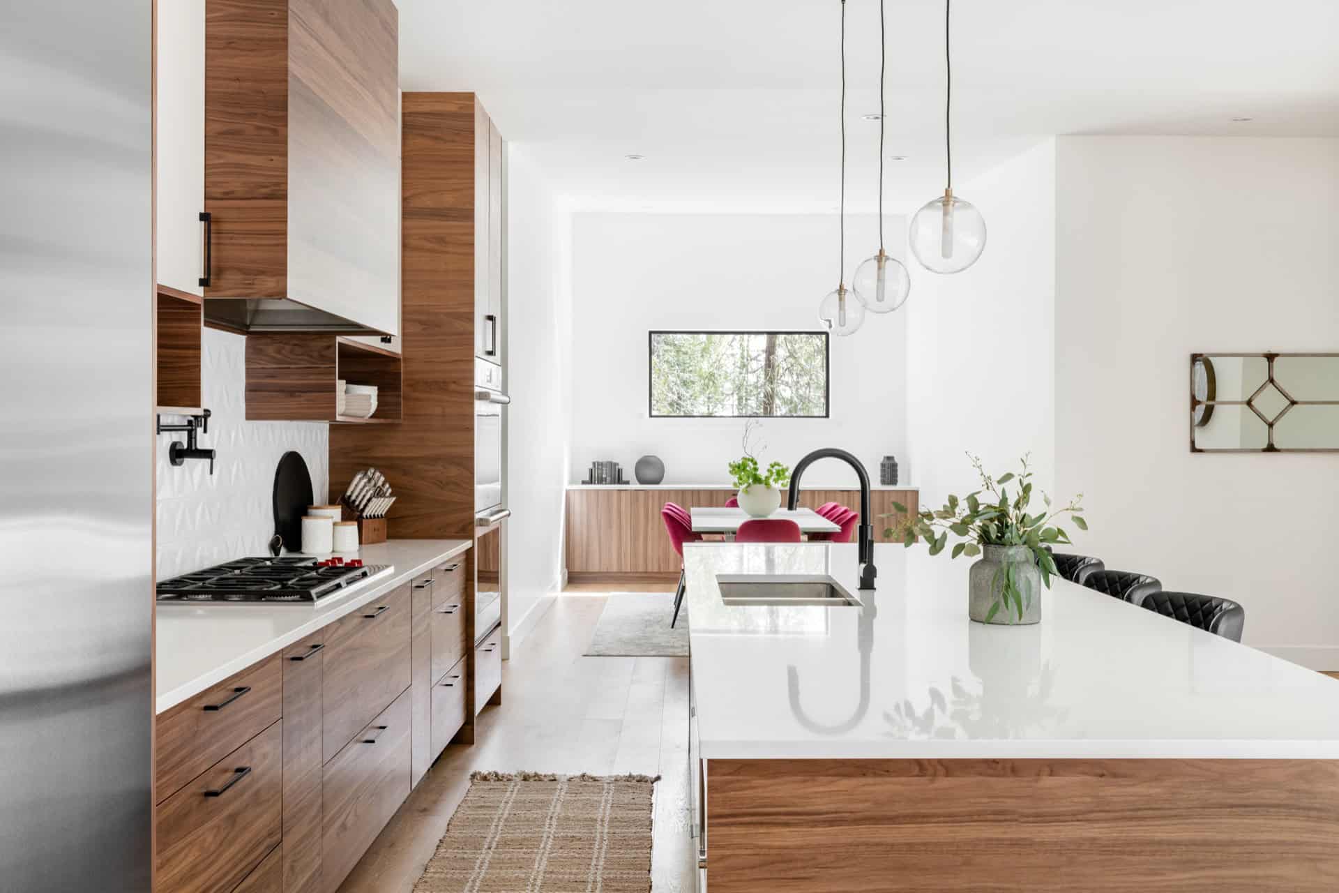 Modern kitchen by White Wolf Homes in Woodside Victoria BC with island and wooden cabinets.