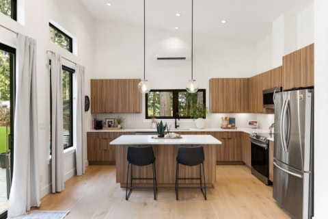 Modern kitchen with wooden cabinets, island and stainless steel appliances in Victoria BC home.