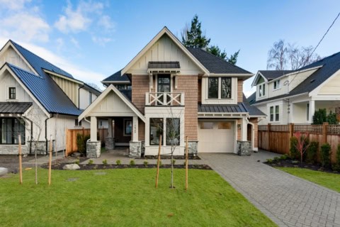 Exterior of a modern custom home by White Wolf Homes in Victoria BC with front lawn and walkway.