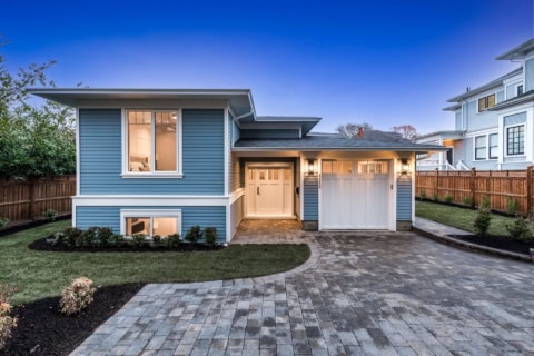 Blue-toned modern home by White Wolf Homes in Victoria BC with paved driveway.