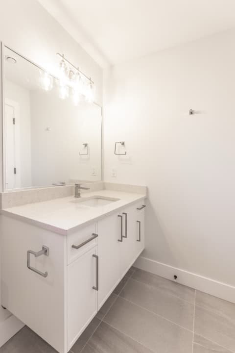 White Wolf Homes bathroom vanity with modern sink and mirror.
