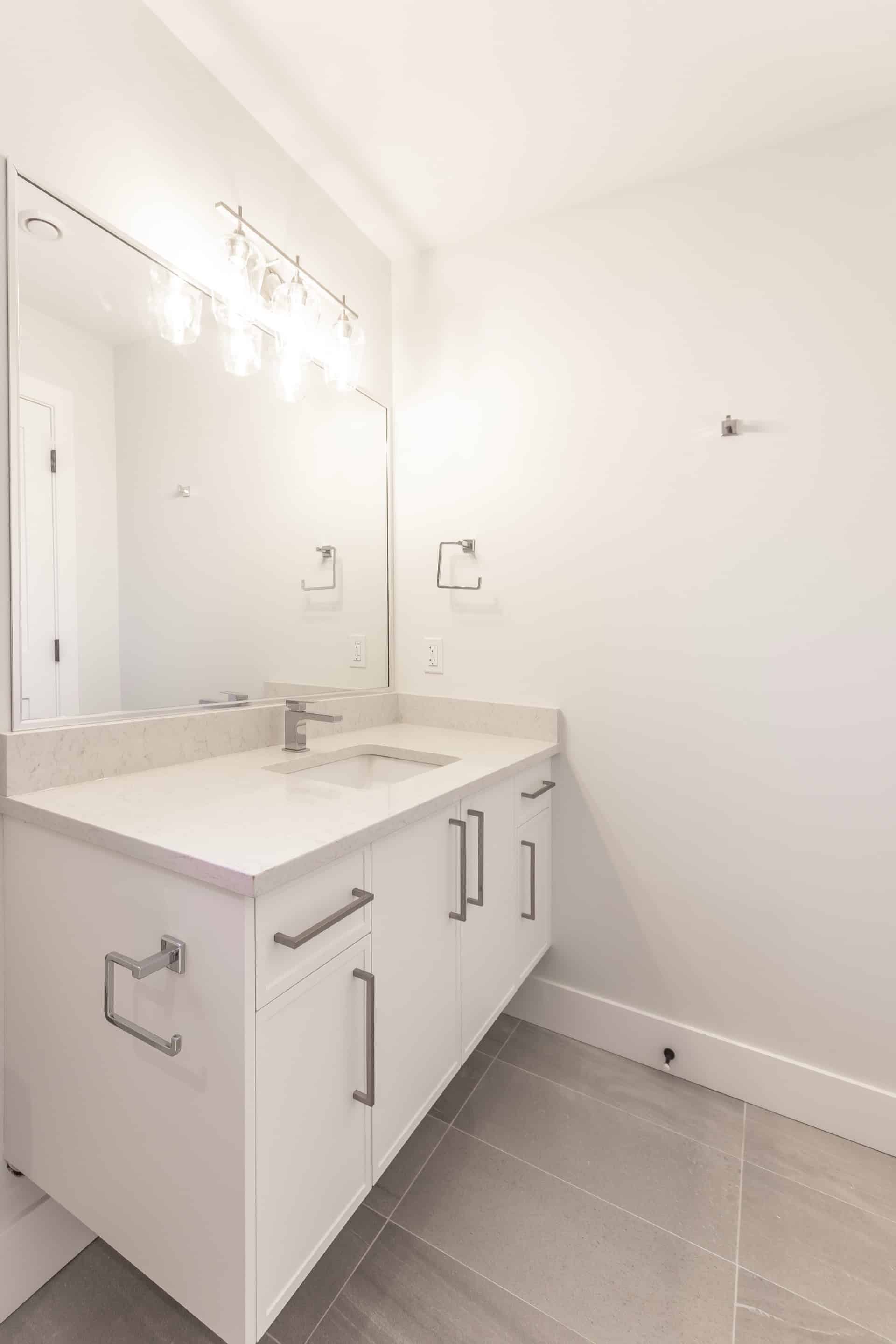 White Wolf Homes bathroom vanity with modern sink and mirror.