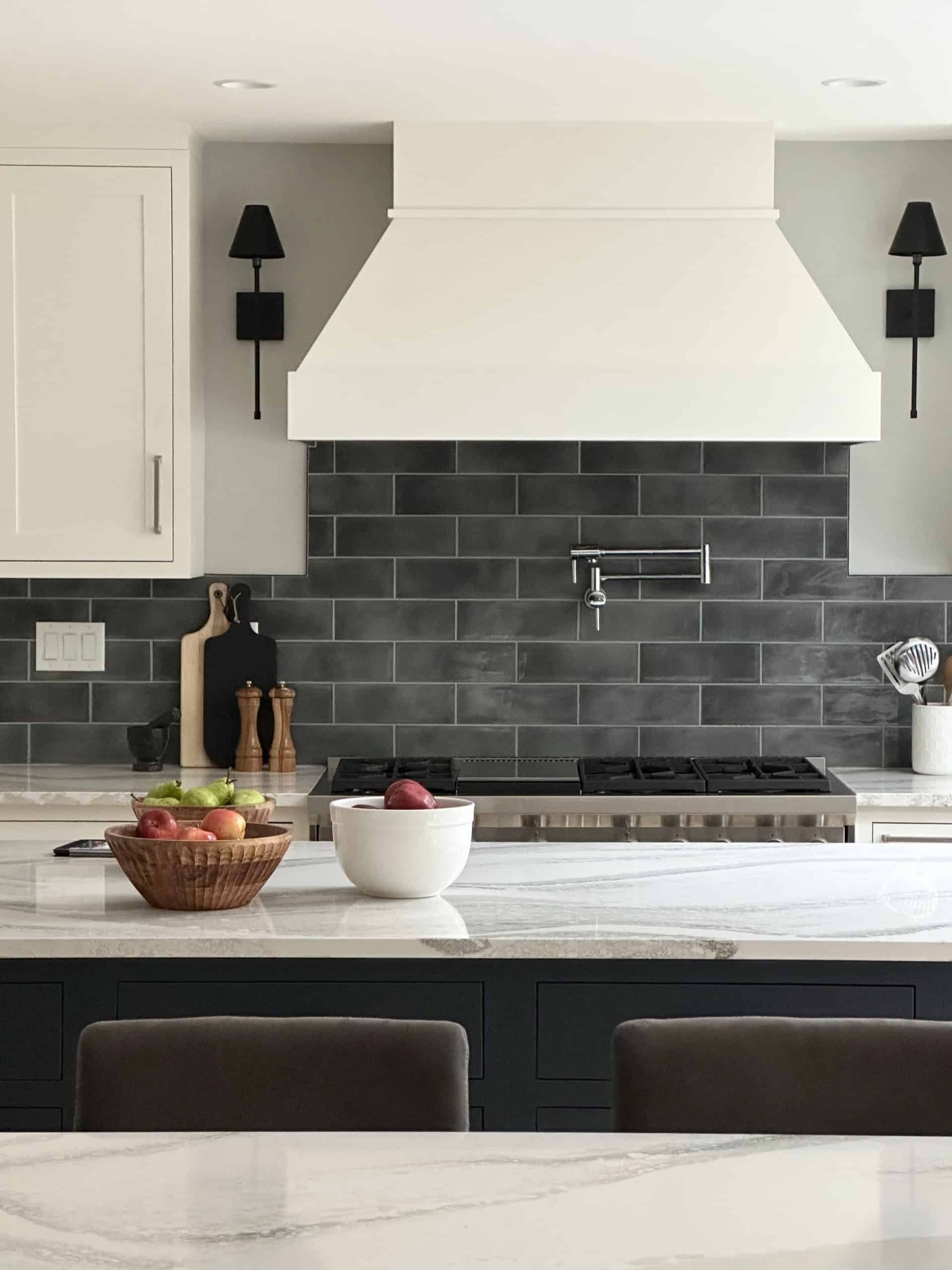 White Wolf Homes modern kitchen with gray hood and subway tile backsplash.