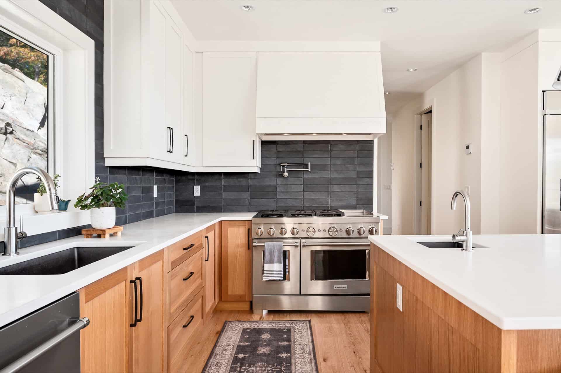 Modern white and wood kitchen in Victoria BC custom home by White Wolf Homes.
