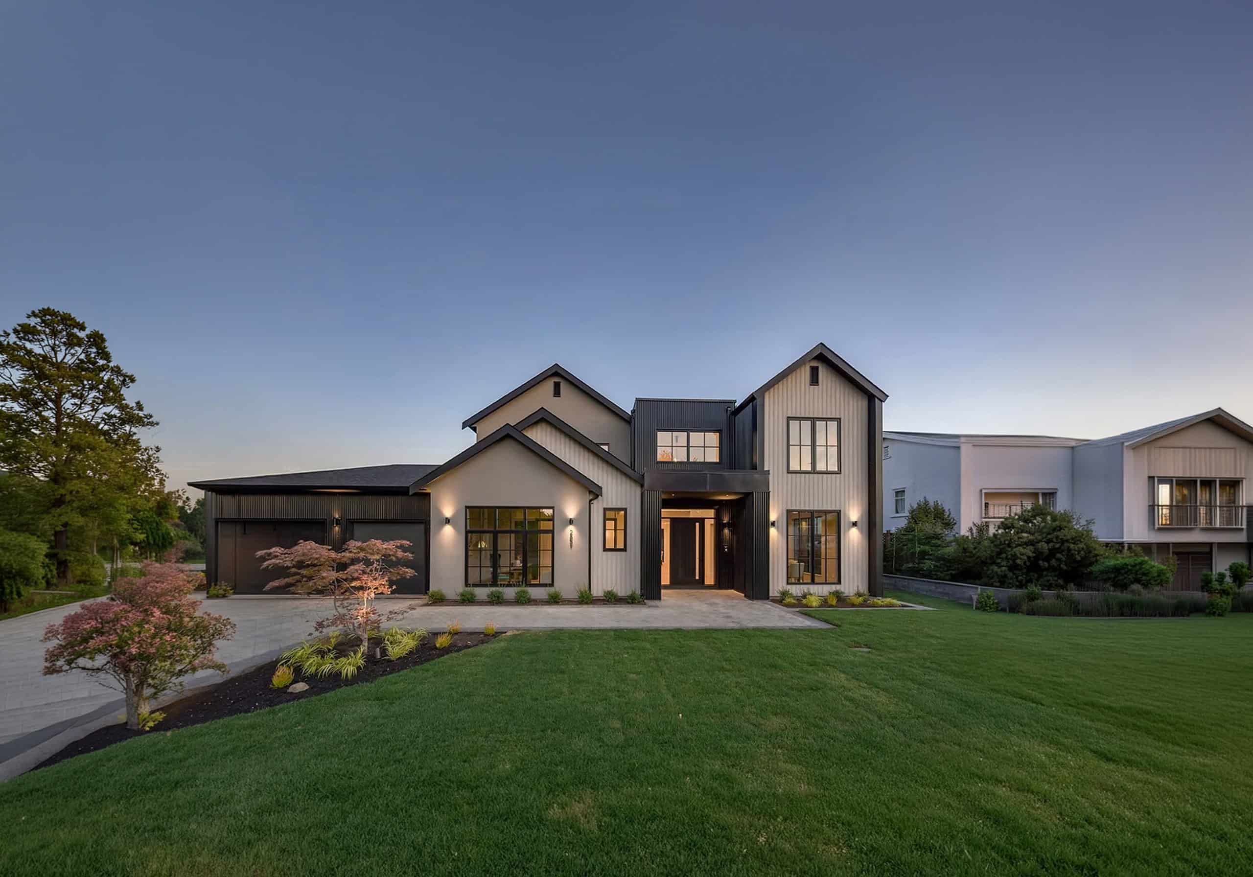 Modern custom home exterior by White Wolf Homes in Victoria BC with manicured lawn and clean lines.